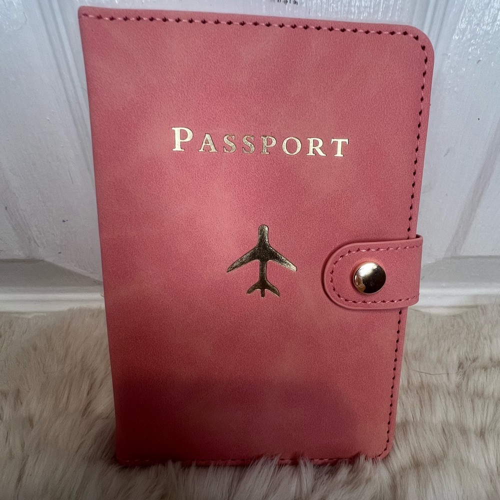 PASSPORT COVER HOLDER WITH GOLD LETTERING AND PLANE DETAIL IN PINK
